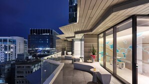 A modern rooftop terrace with a glass balustrade, seating areas, and a view of the cityscape. - W Melbourne (Melbourne)