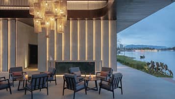 Relax by the water with a warm fire and modern seating.