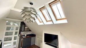 A modern kitchen with a built-in dishwasher, a large window, and a ceiling fan. - A Spacious, Modern & Contemporary Loft Space (Wickham Market)