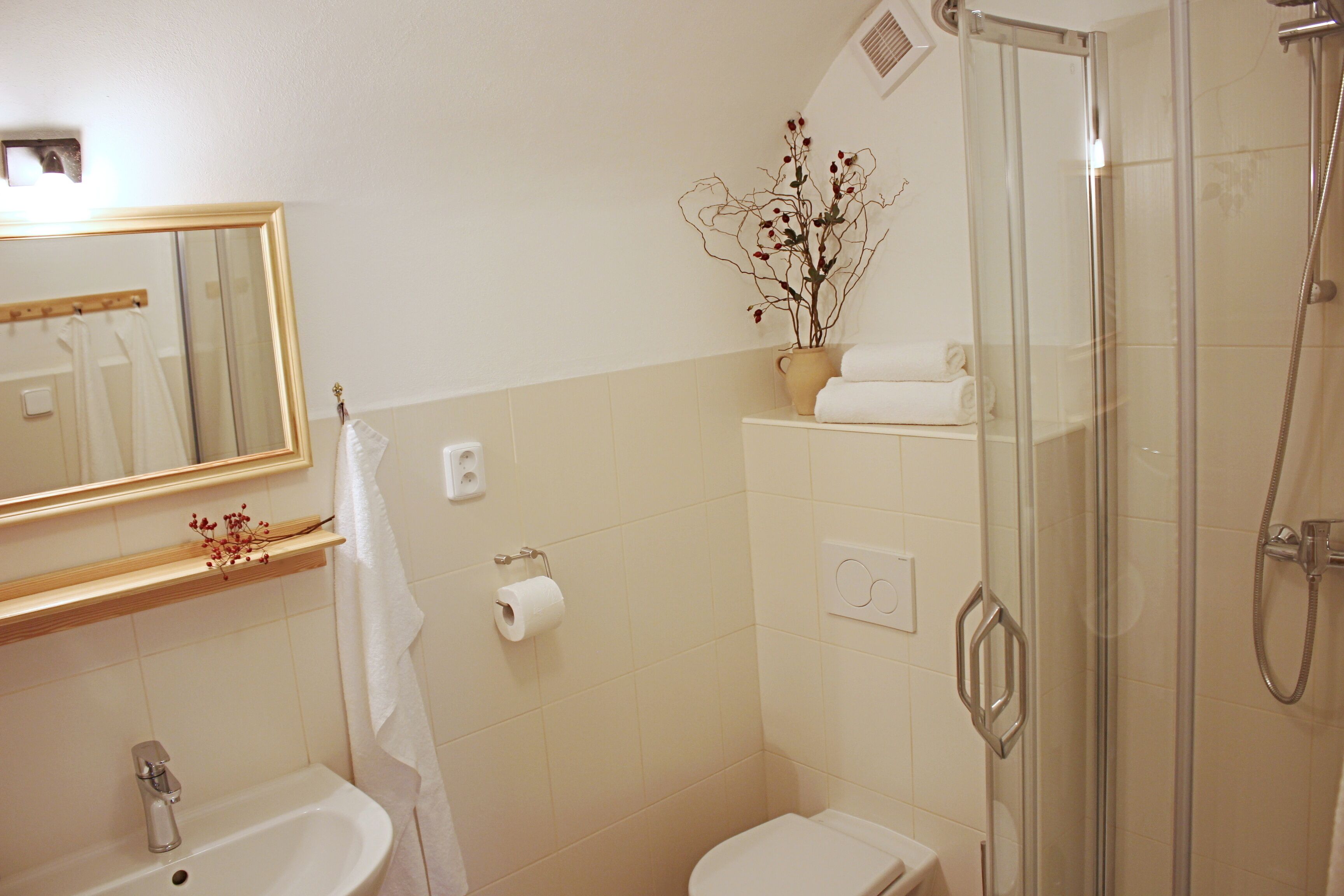 A bathroom with a sink, toilet, and shower.