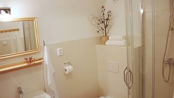 A bathroom with a sink, toilet, and shower.