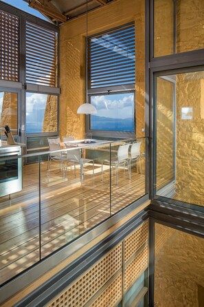 A modern kitchen with a wooden countertop and stainless steel appliances. - Eleni's Serenity - Discovering Sapphire Harmonies (Ravdoucha)