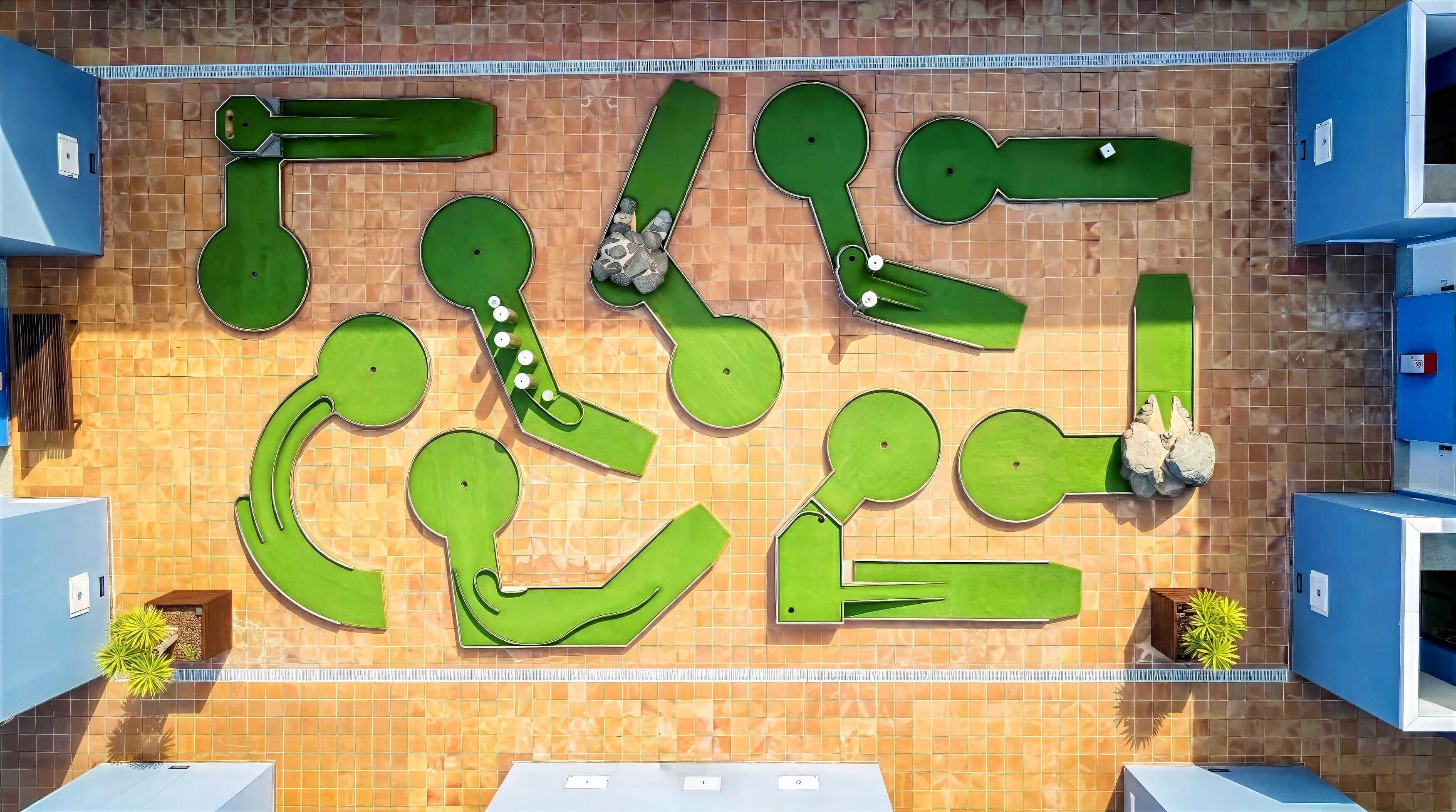 A pool area with multiple lanes and a surrounding tiled wall.