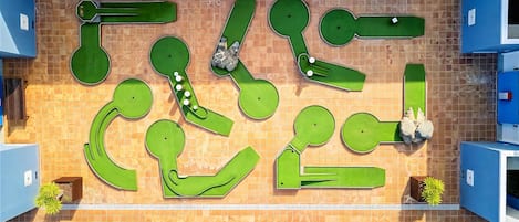 A pool area with multiple lanes and a surrounding tiled wall.