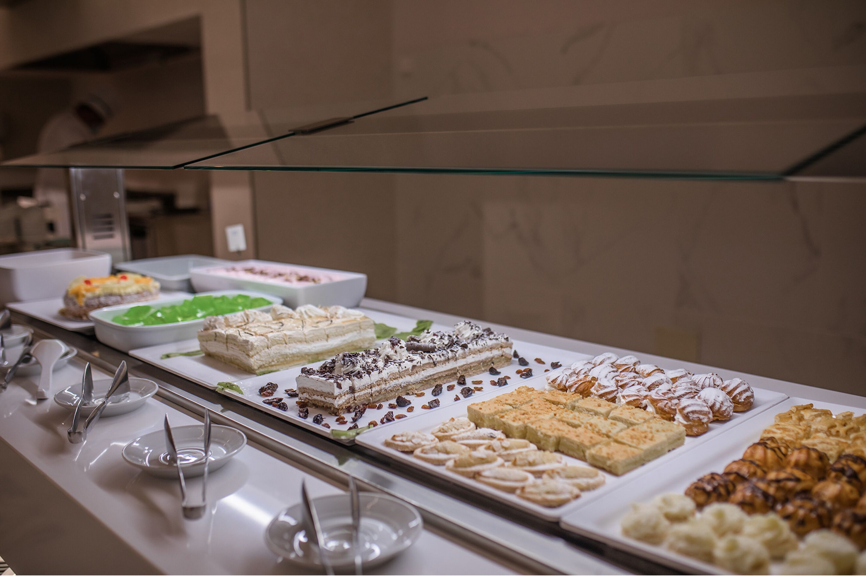 A buffet with various desserts and pastries.