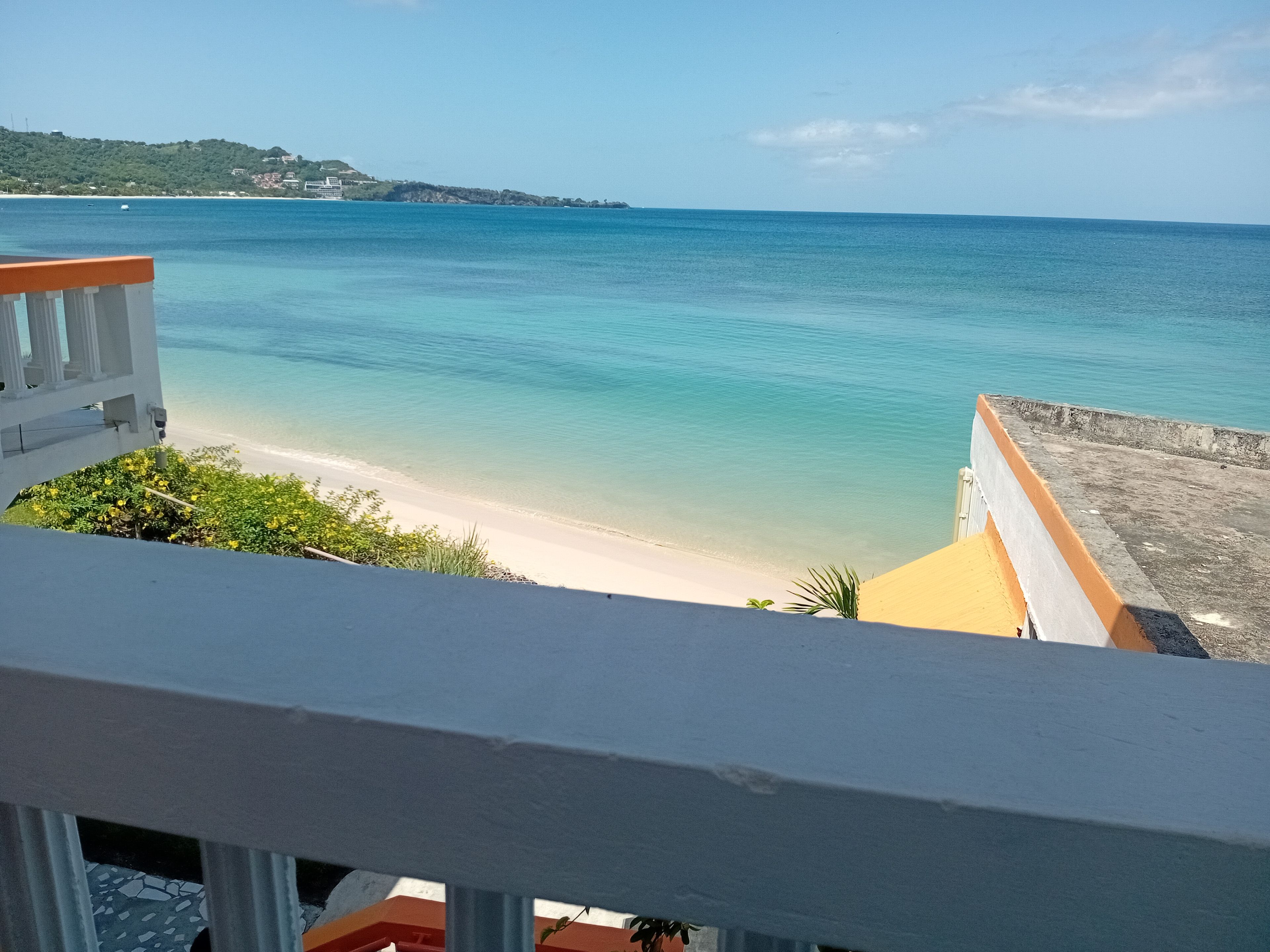 Un balcón con vista a la playa y el océano.