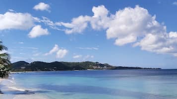 On the beach, white sand, sun loungers, beach towels