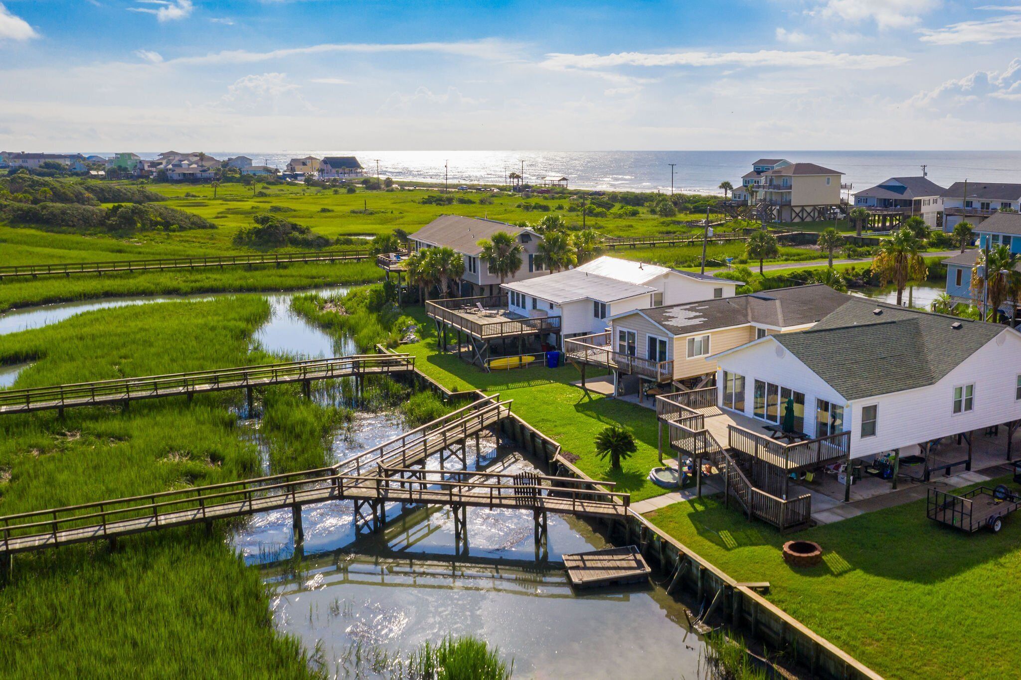 A coastal residential area with houses, a bridge, and a water body.