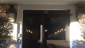 A building entrance with a sign reading "Triolet" and a door marked with the number "105". - Cham-Vue Apartment (Chamonix-Mont-Blanc)