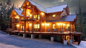 A large, multi-level log cabin with a metal roof, multiple balconies, and a deck area. - Spectacular Luxury Lodge Home w/Hot Tub, Sauna on Private Lake Sleeps 16-20 Bend (Bend)