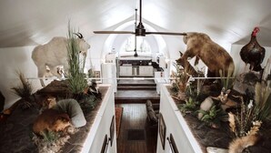 A room with a high ceiling, a central ceiling fan, and a long table. - THE OLD CHURCH INN is a luxurious Property near Salmon River (Altmar)