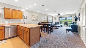 A spacious living area with a kitchen, dining table, and a view of the outdoors. - Clean & Spacious 2BR/2BA.  Gated resort with amenities (Branson)
