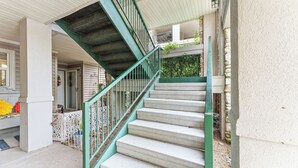 A staircase with green railings leading to a second floor. - Clean & Spacious 2BR/2BA.  Gated resort with amenities (Branson)