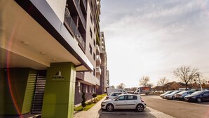 A modern building with a green entrance labeled "PRIMA RESIDENCE." - Bright & Elegant Central Apartment (Oradea)