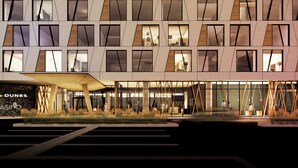 A modern building with a geometric facade, large windows, and a visible entrance area with steps leading up to the door. - Dakota Dunes Resort (Whitecap)