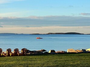 Relax in a serene lakeside setting with Adirondack chairs and enjoy water activities.