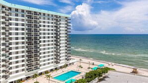 A high-rise hotel with a pool area, beachfront view, and multiple balconies. - The Tides Ocean Luxury Suites (Hollywood)