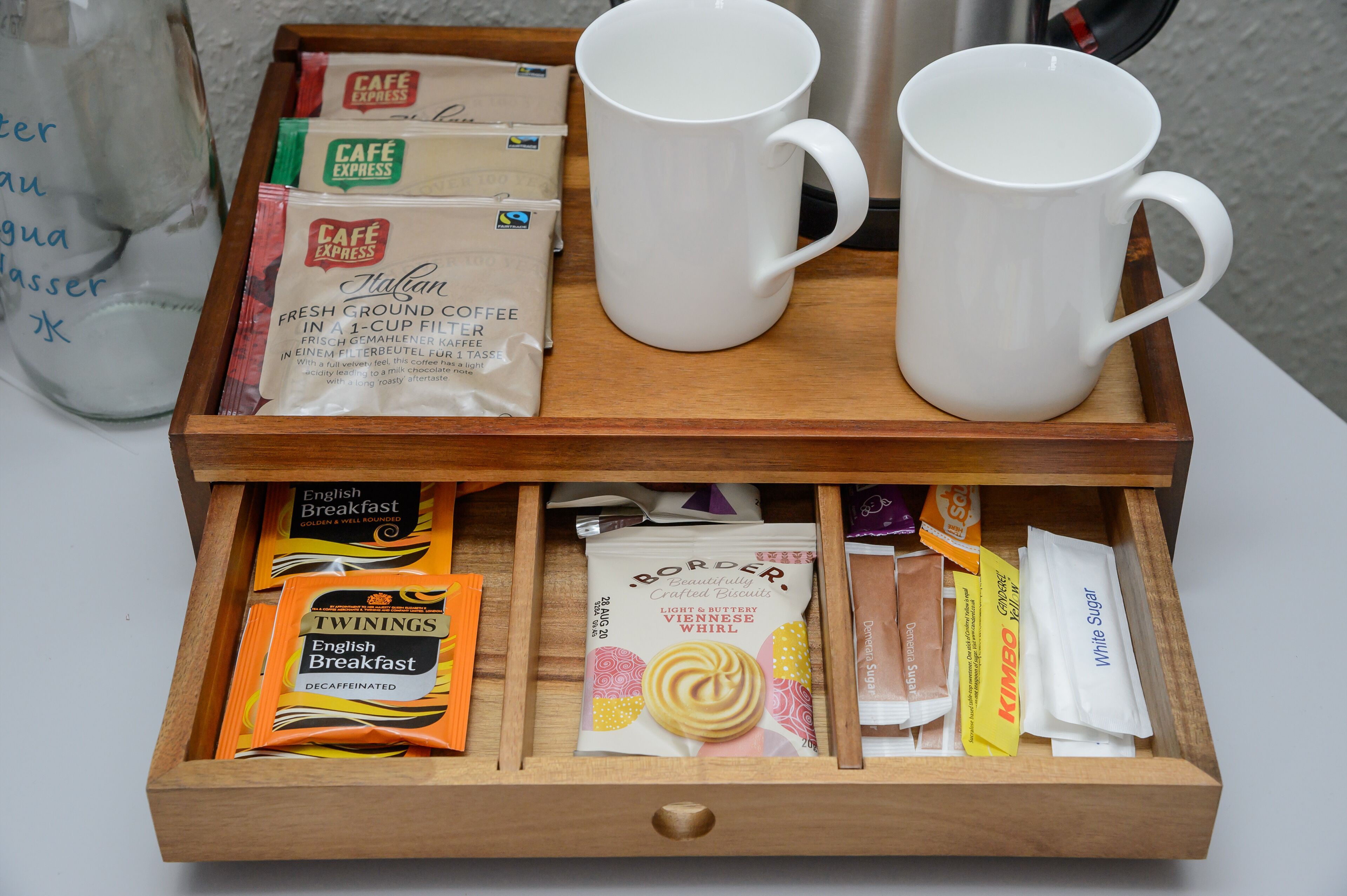 A tray with two white mugs and various breakfast items including Café Express and Twinings English Breakfast.