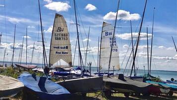 Sailboats docked at a marina with clear skies.