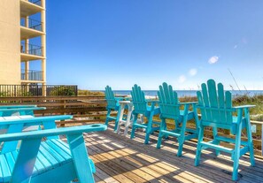 Relax on the oceanfront deck with Adirondack chairs and a small table.