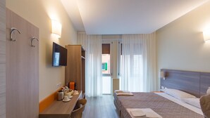 A hotel room with a bed, a desk, a chair, a television, and a window with curtains. - San Felice 135 - 3 (Bologna)