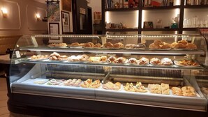 A bakery display case with various pastries and sandwiches. - San Felice 135 - 3 (Bologna)