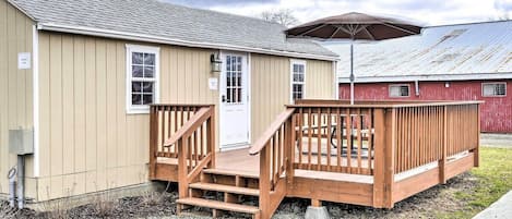 A single-story building with a wooden deck and a covered area.