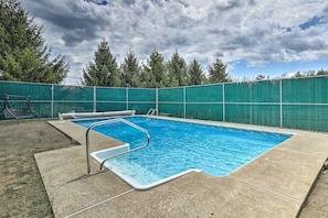 A rectangular swimming pool with a metal ladder and a concrete deck. - Double Retreat · Poconos Nature Escape (Pleasant Mount)