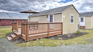 A single-story building with a wooden deck and a covered patio area.