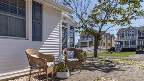 A residential house with a porch, wicker chairs, and a potted plant. - Perfect beach cottage for your Lewes vacation! 10 Texas (Lewes)
