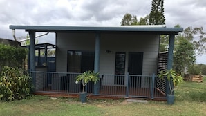 A single-story house with a covered porch and a fenced yard.