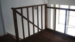 A wooden staircase with a white wall and a window on the right. - THE TOTAL APPARTMENT IS YOURS ALONE (BUDAPEST)