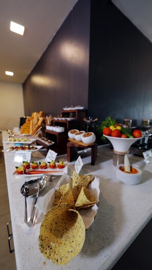 A buffet table with various food items and condiments. - The Altruist Whitefield Hotel (Bengaluru)