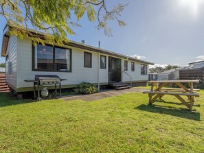 Enjoy a home away from home with a front porch and backyard perfect for outdoor dining and relaxation.