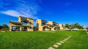 A modern residential building with multiple balconies and large windows. - Miroes Suites (Sithonia)