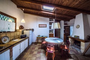 Cozy kitchen with a rustic charm, featuring a sink, refrigerator, and toaster, perfect for preparing meals.