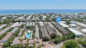 A coastal residential area with a large pool and multiple buildings. - 🦩Book Me Baby! Destin Delight in The Villages of Crystal Lakes🦩 (Destin)