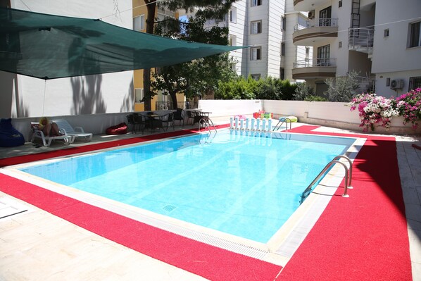 Outdoor pool, open 9:00 AM to 7:00 PM, pool umbrellas, pool loungers