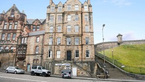 A historic stone building with multiple windows and a prominent entrance.