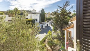 A residential area with white houses, a cobblestone street, and lush greenery. - La Manga Club Las Brisas Villa 514 (La Manga Club, Cartagena)