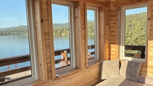 A cabin with large windows, wooden walls, and a wooden deck overlooking a lake. - PRIVATE ISLAND RETREAT On Gorgeous Flathead Lake Montana!!! (Somers)