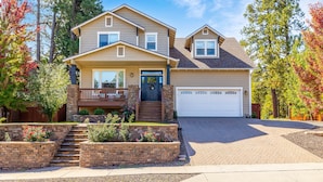 A two-story house with a front porch, a garage, and a landscaped front yard. - Separation Canyon Retreat (Flagstaff)