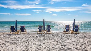 A beach with rows of beach chairs and umbrellas, arranged in a line facing the ocean. - Stunning Village Condo, Overlooking 30A, Beautifully Decorated Recently Updated (Seacrest Beach)