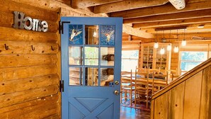 A wooden interior with a blue door, wooden walls, and a staircase. - The Creek-Side Cabin: Hot Tub, Fire Pit,5 Star, AC, Big Deck, Quiet,Walk To Town (Idyllwild-Pine Cove)