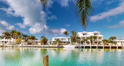 Beachy getaway with pool, water views, furnished patio, & dock access