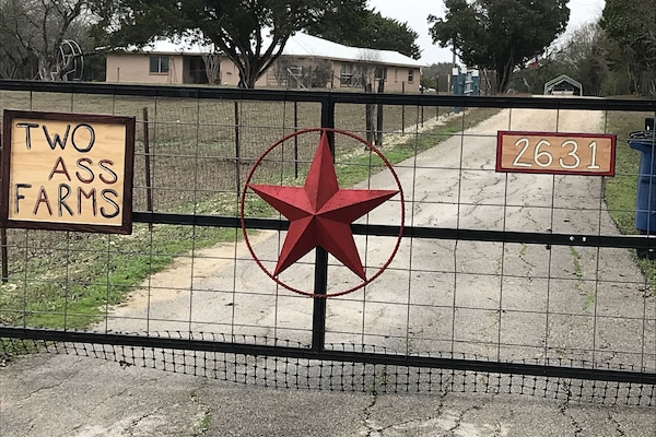 The gate welcoming you to Two Ass Farms.
