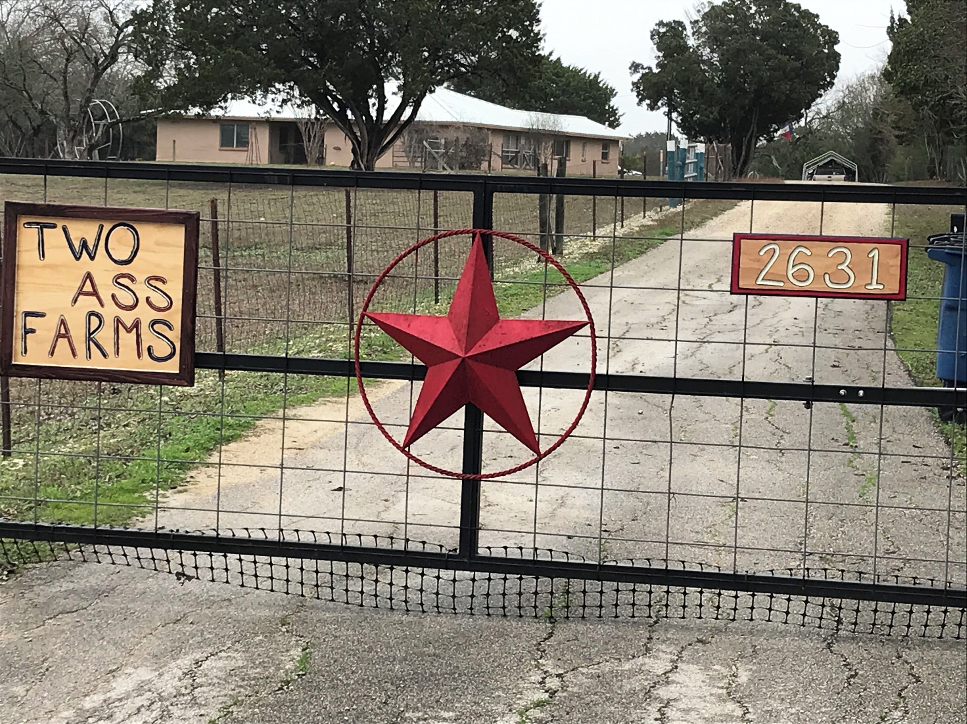 The gate welcoming you to Two Ass Farms. 