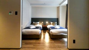 A hotel room with two beds, a wooden floor, and a modern design. - Hotel S-presso South (Osaka)