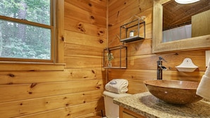 A wooden cabin bathroom with a wooden toilet, a granite countertop sink, a mirror, and a window. - The Mason Jar At Cherry Log | Cherry Log, GA (Cherry Log)