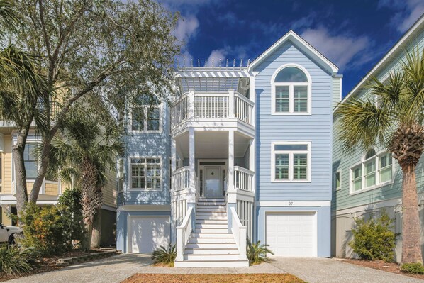 A two-story house with a balcony, a front porch, and a garage.